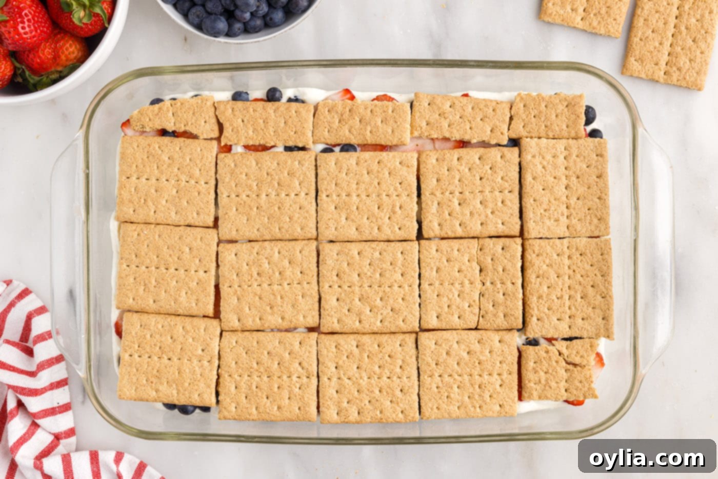 graham crackers layered over berries in a baking dish
