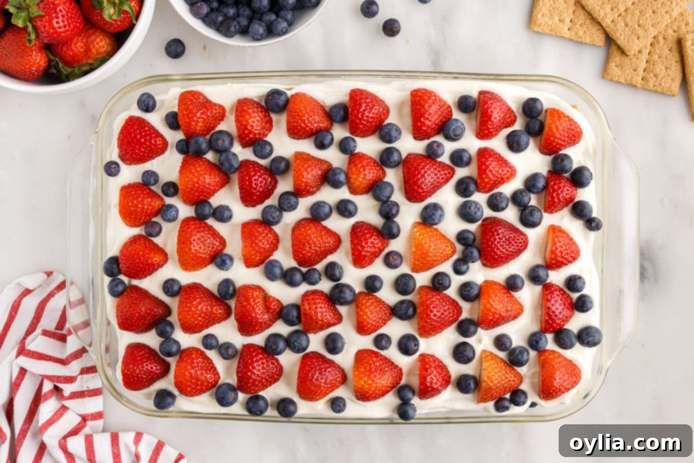 strawberries and blueberries on top of mixed berry icebox cake