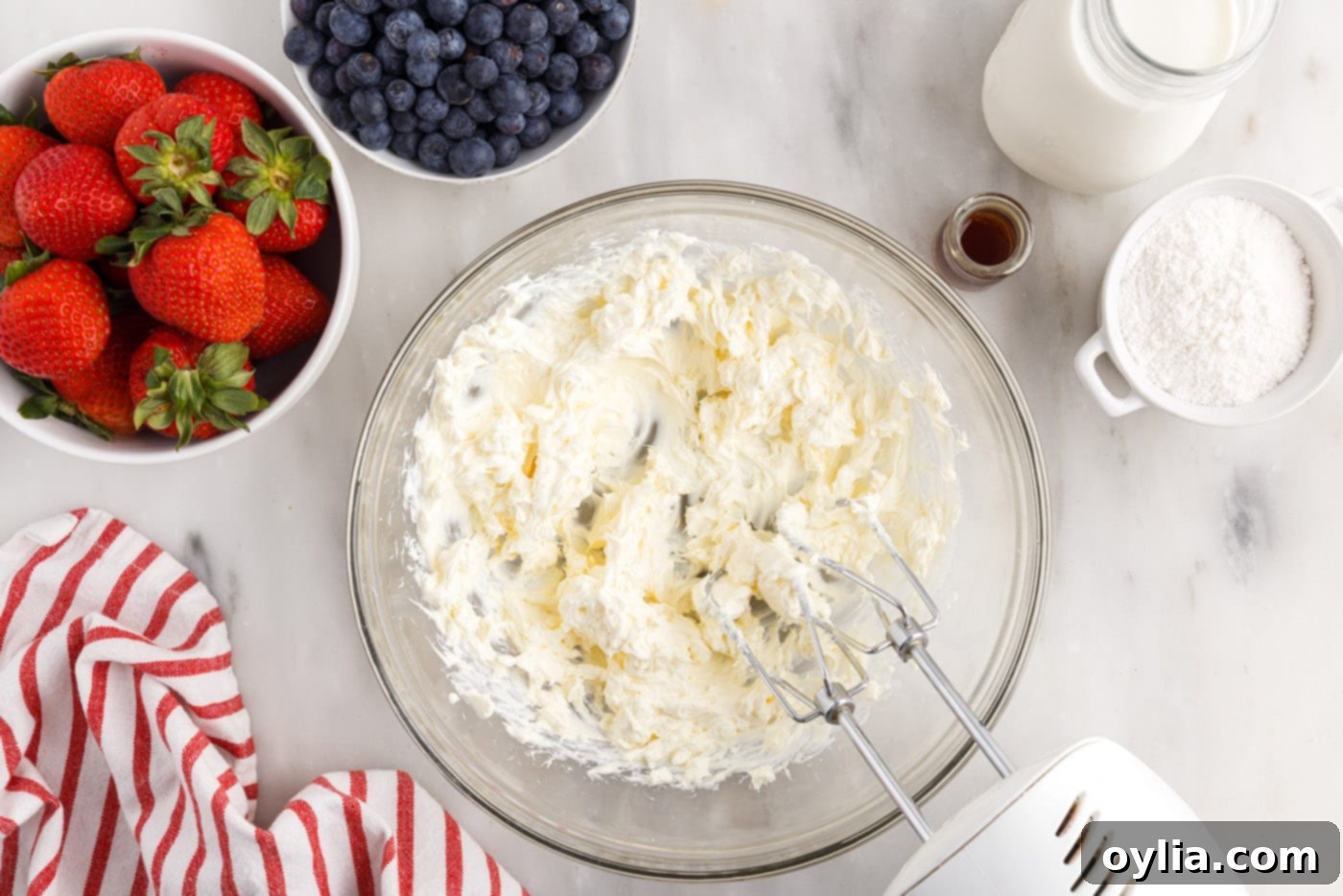 cream cheese beaten in a bowl with a mixer