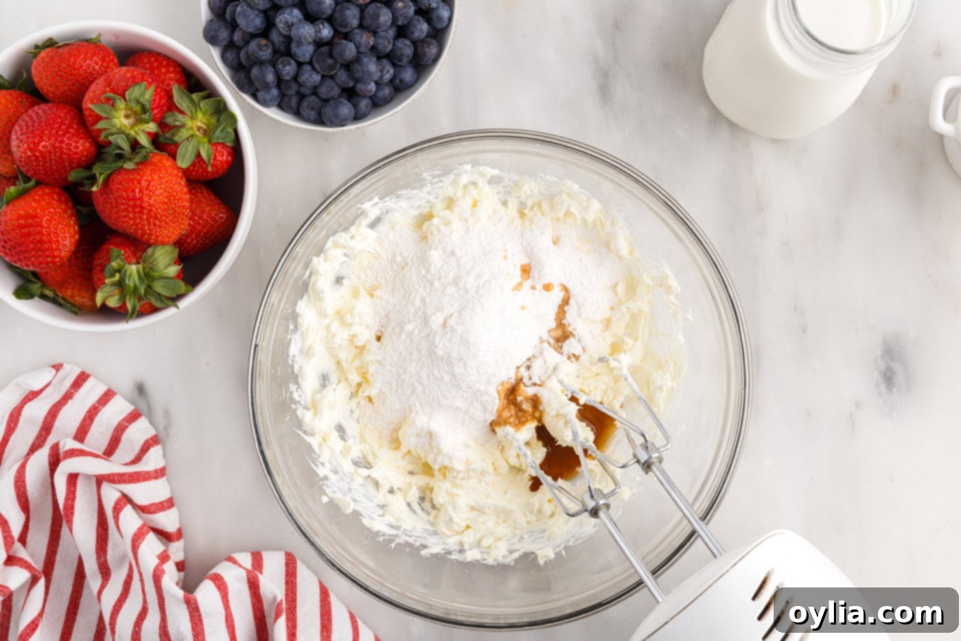 cream cheese, pudding mix, milk, and vanilla mixed in a bowl