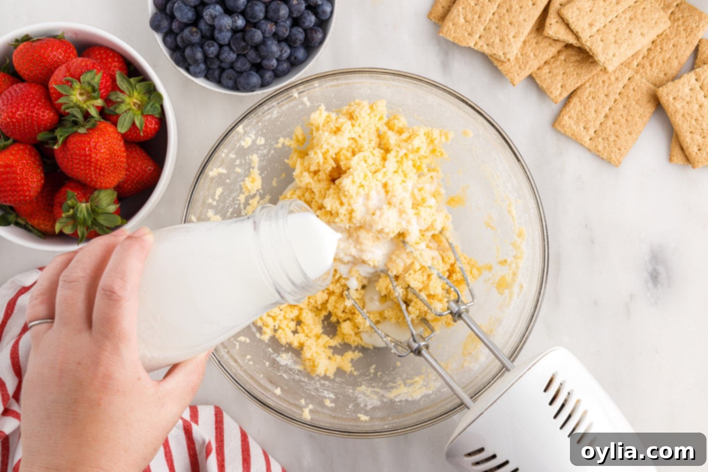 adding milk to cream cheese mixture