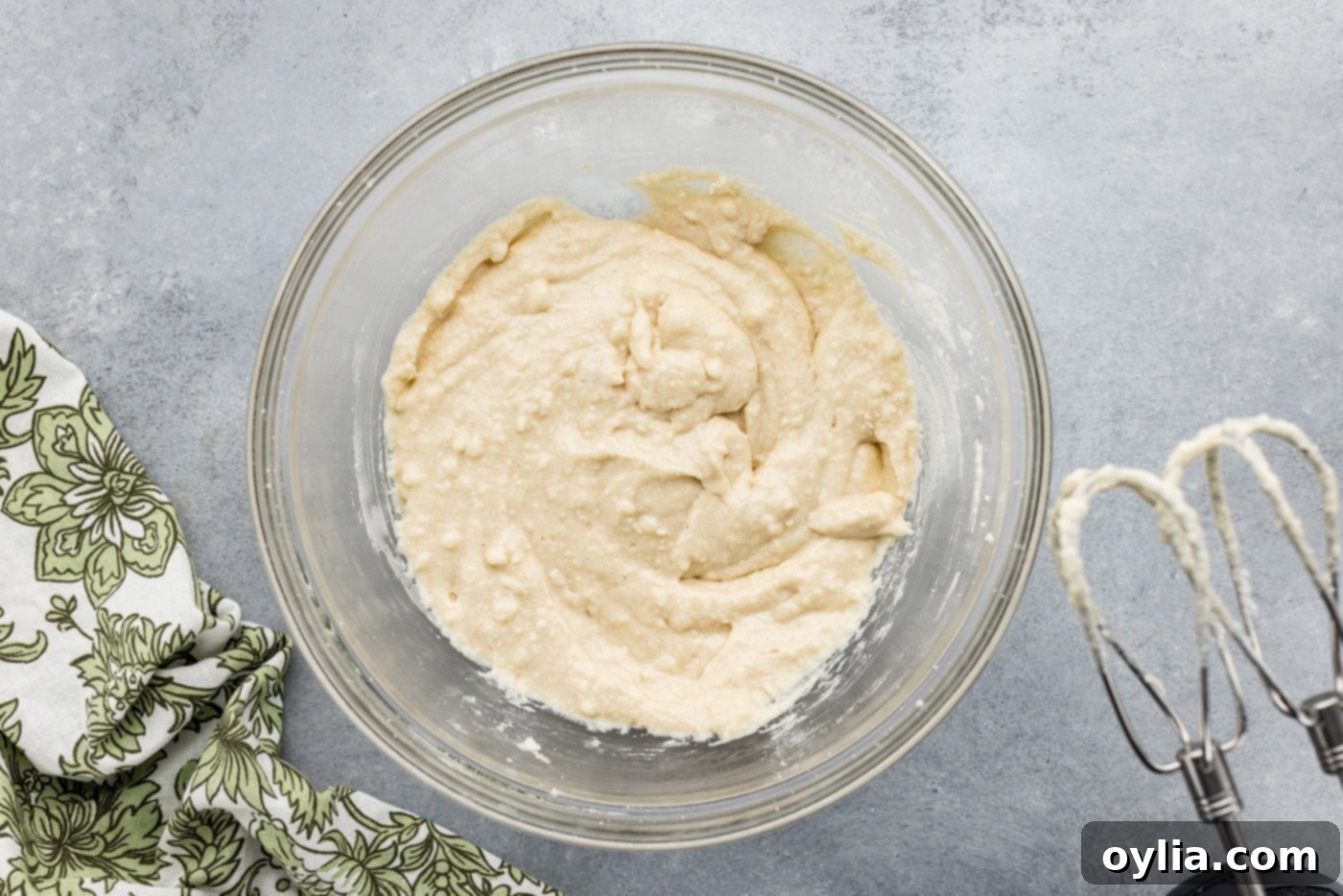 Overhead view of the smooth, thick cobbler batter in a mixing bowl after all ingredients have been combined.