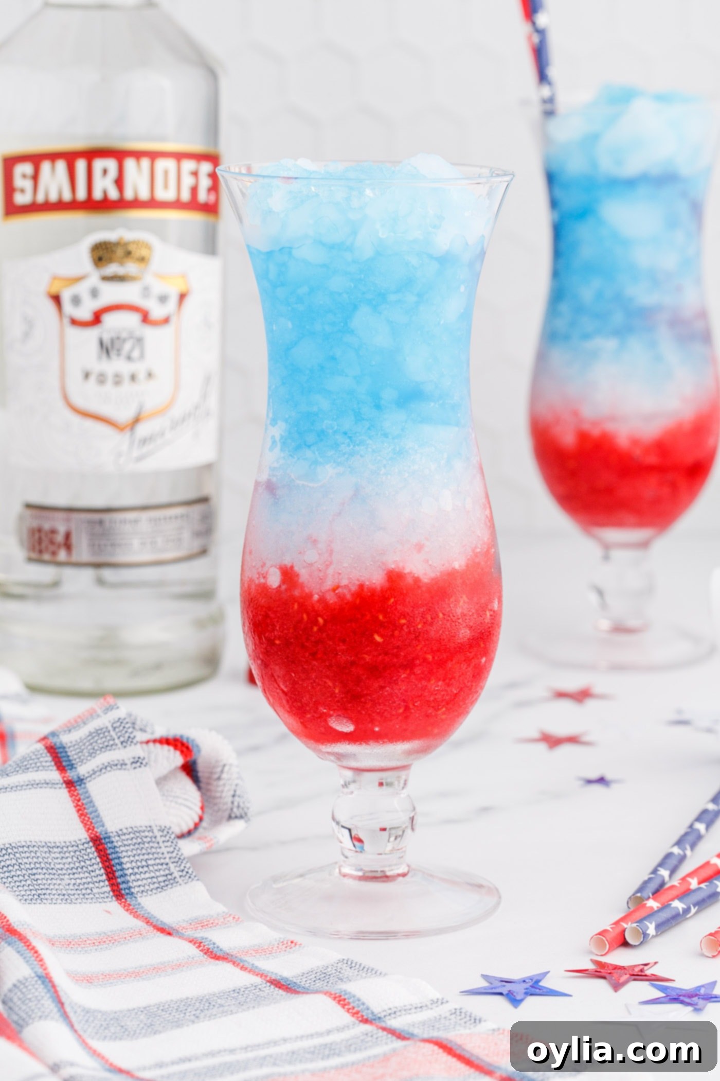 Finished layers of raspberry, lemonade, and blue curacao in a drink glass