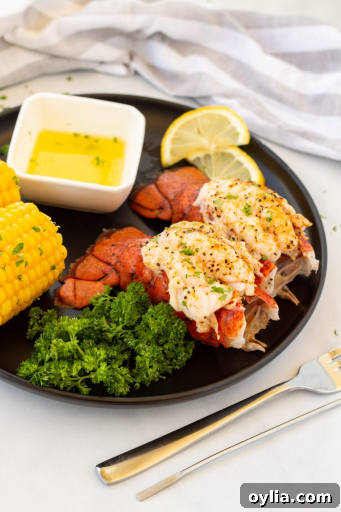 Tender Steamed Lobster Tail 3 Two perfectly crowned steamed lobster tails on a plate, ready to be served