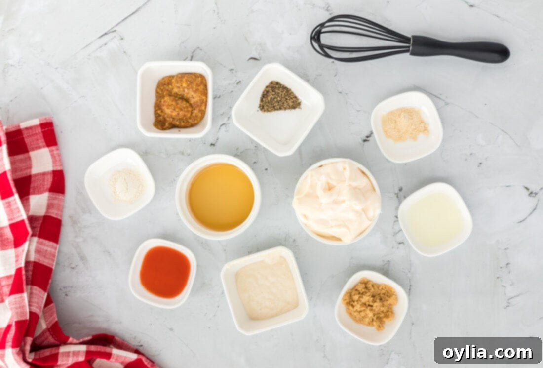 Collection of Alabama White Sauce ingredients laid out, including mayonnaise, apple cider vinegar, coarse ground mustard, and various spices
