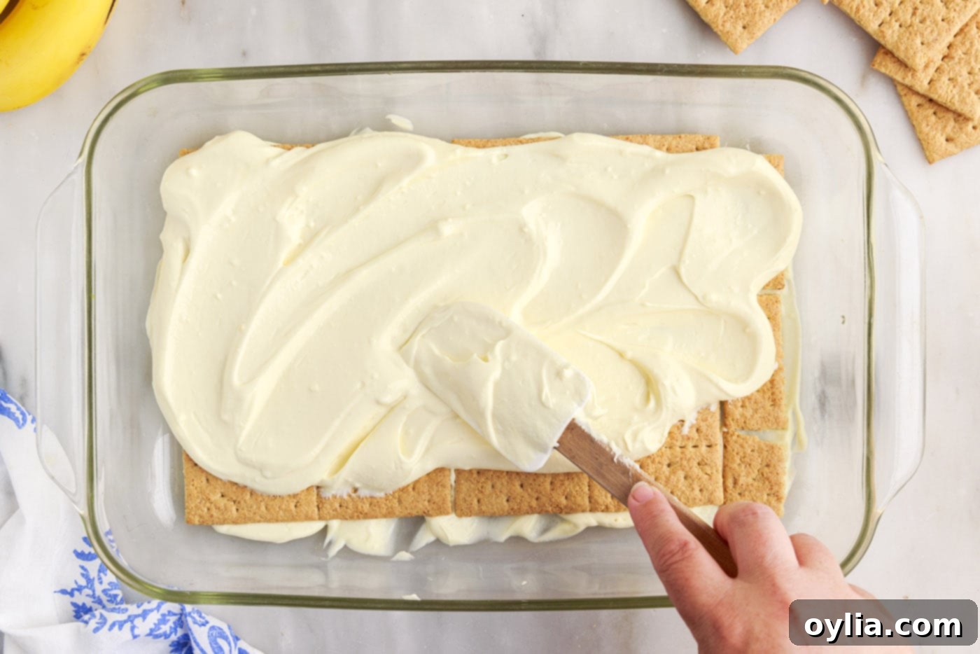 spreading banana cream pudding on top of graham crackers