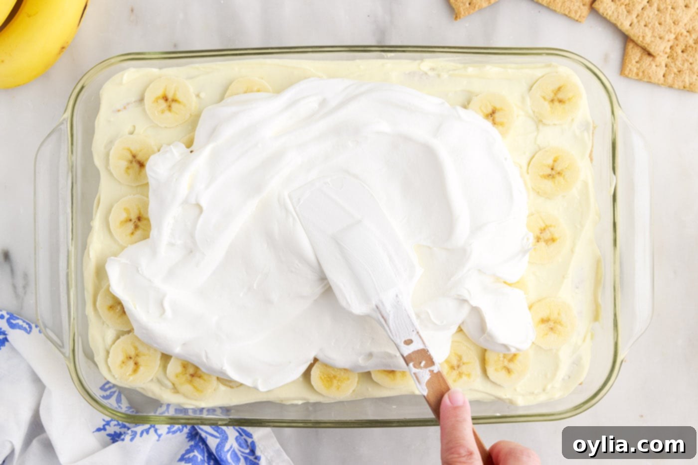spreading cool whip over the top of banana cream pie icebox cake