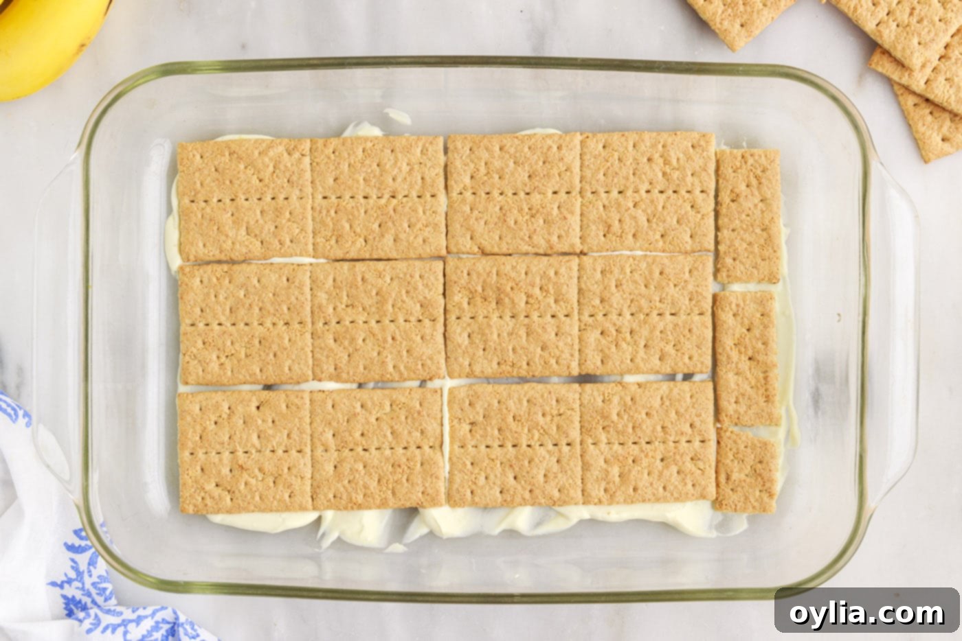 graham crackers on top of pudding mixture in a baking dish