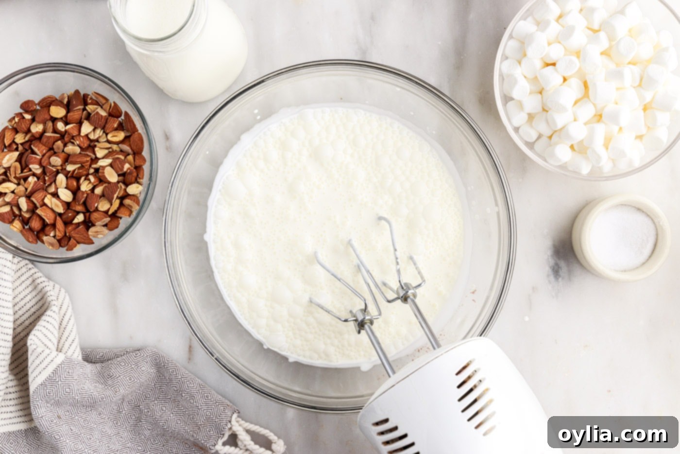 hand mixer whipping heavy cream in a bowl