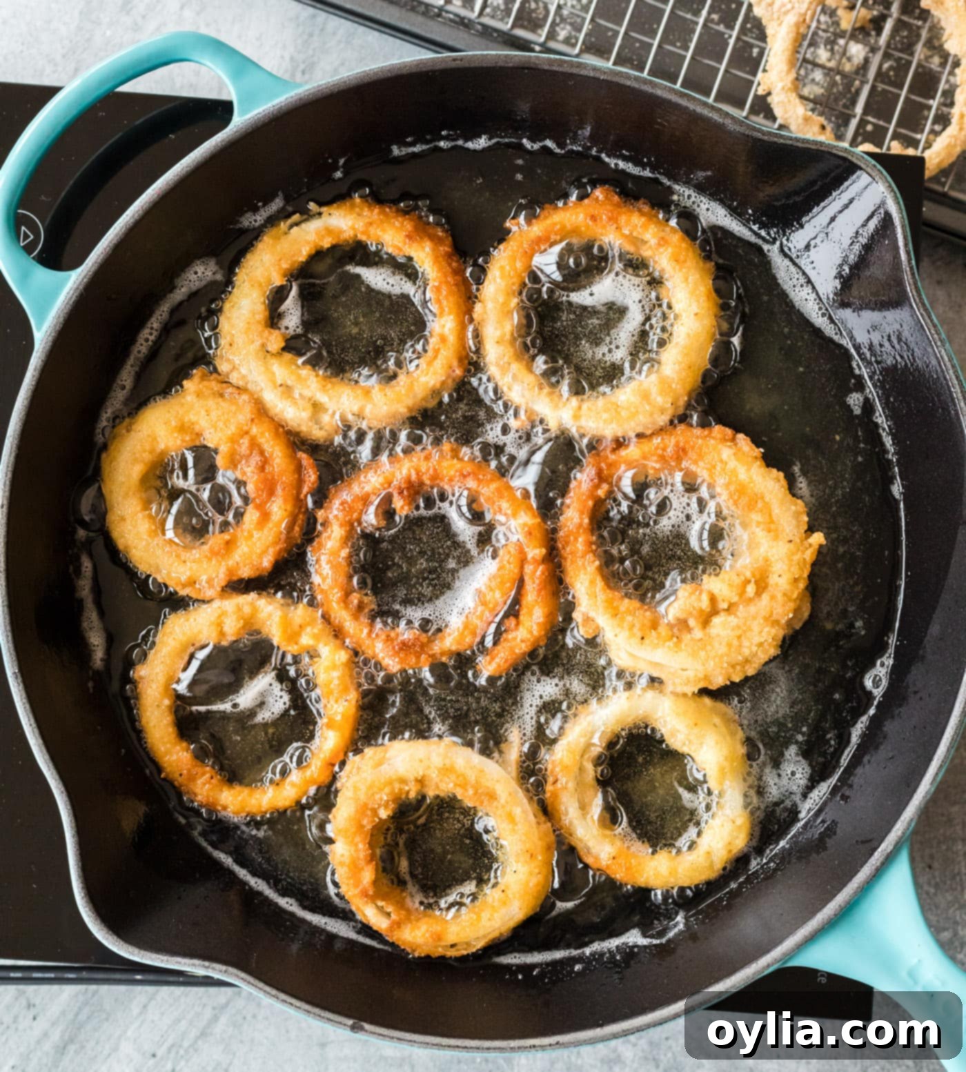 deep fried onion rings in a skillet