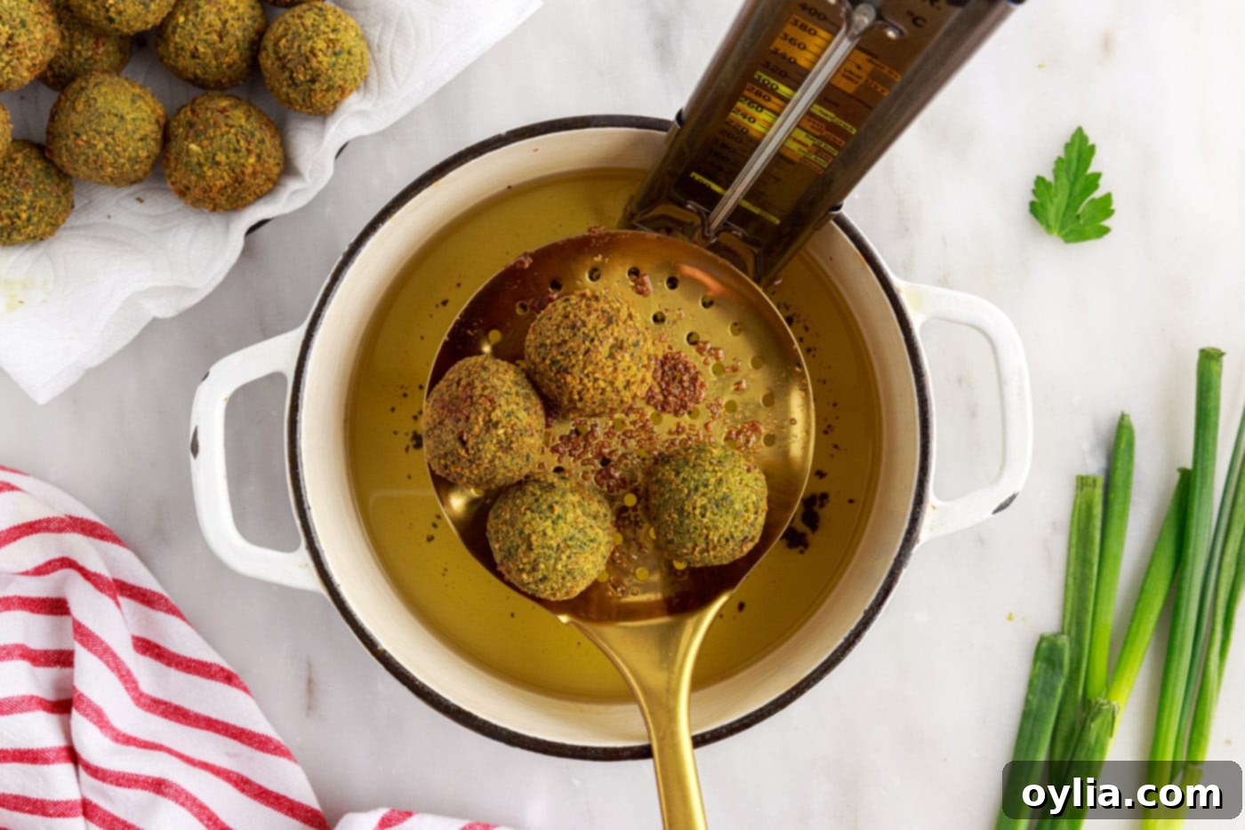 Freshly fried golden-brown falafel balls resting on paper towels.
