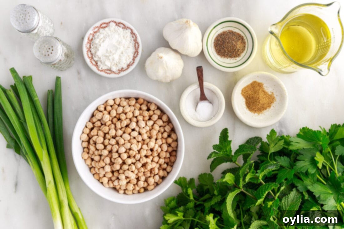 Fresh ingredients laid out for making falafel, including chickpeas, herbs, and spices.