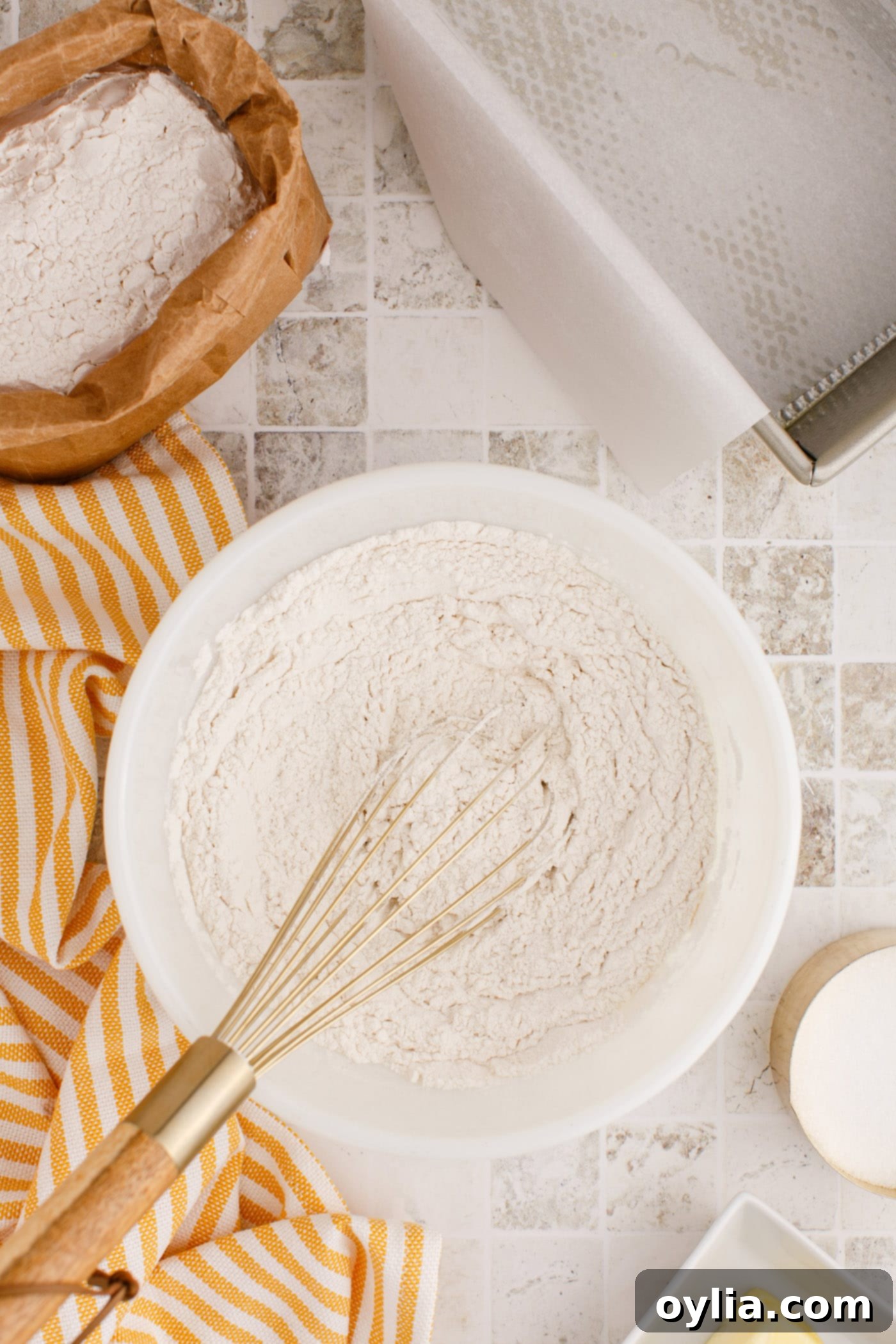 whisking the flour and dry ingredients for quick bread in a bowl