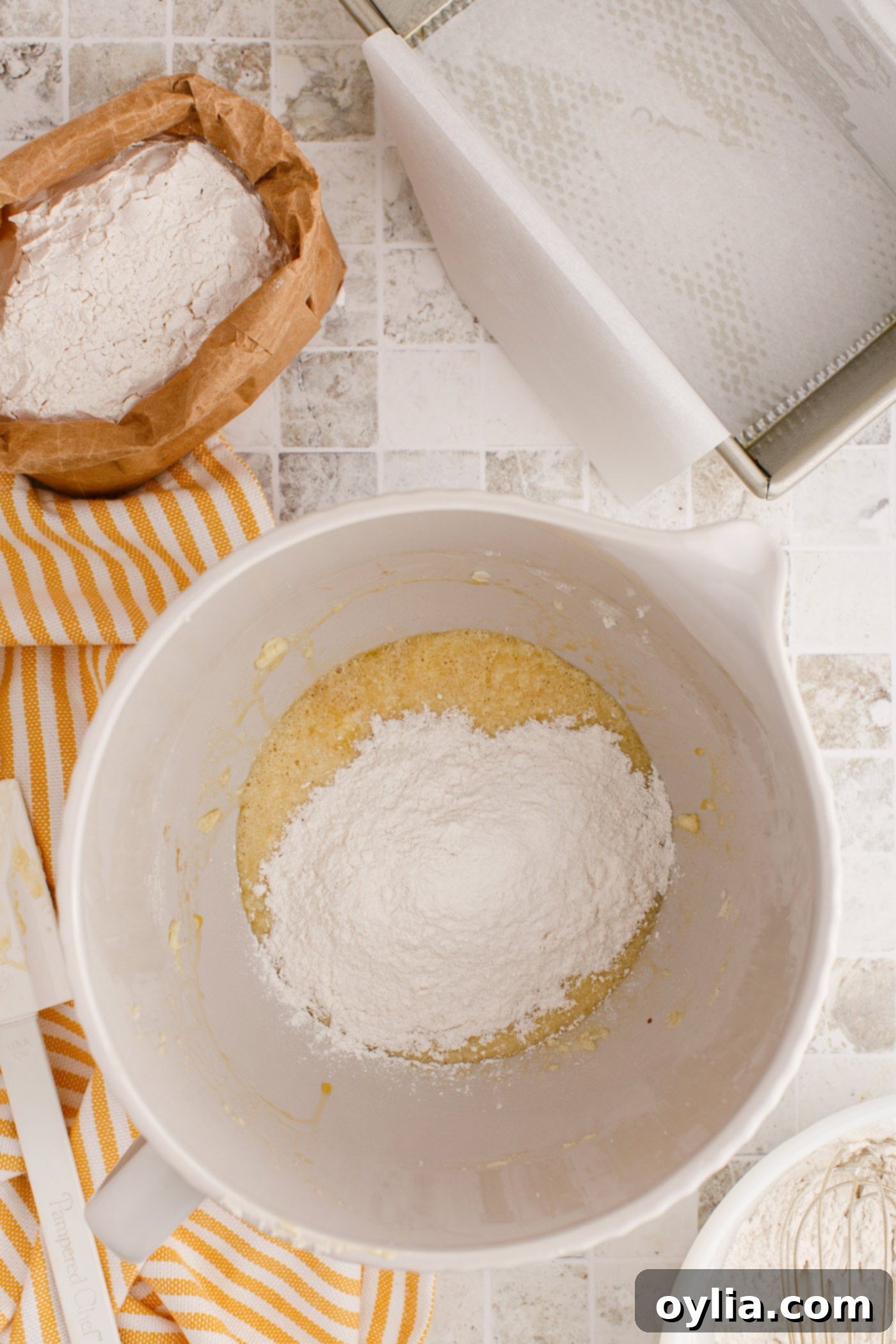 adding flour mixture to creamed butter, sugar, and eggs