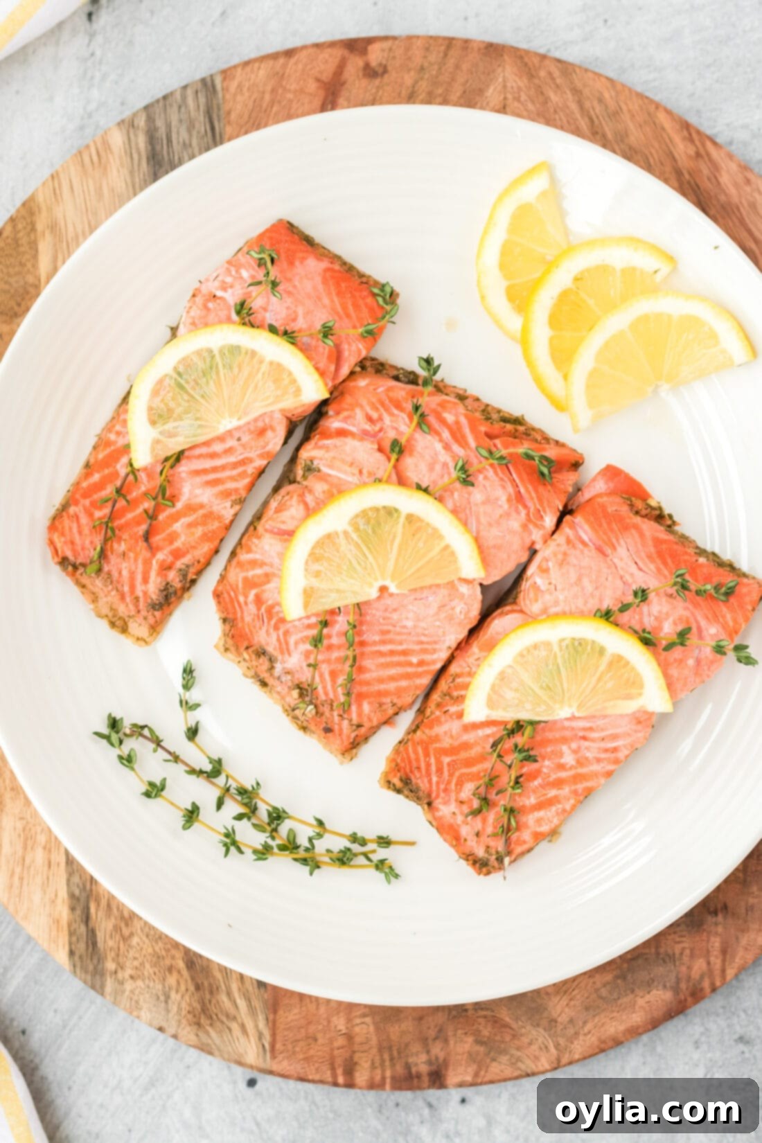 Silky Poached Salmon 3 plate of Poached Salmon garnished with lemon and fresh dill