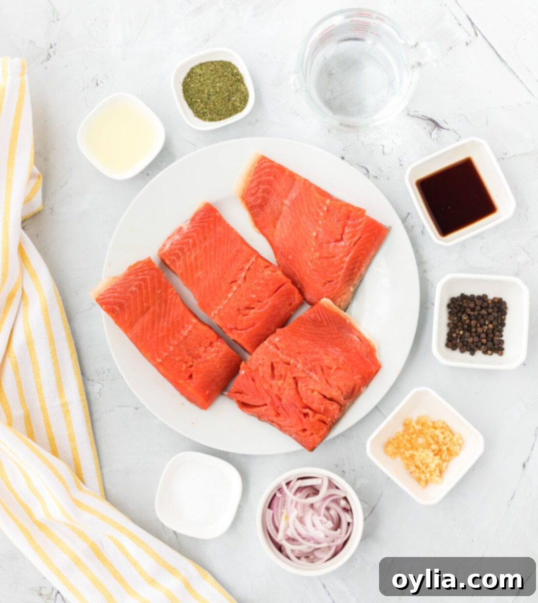 Silky Poached Salmon 4 Poached Salmon ingredients laid out on a table