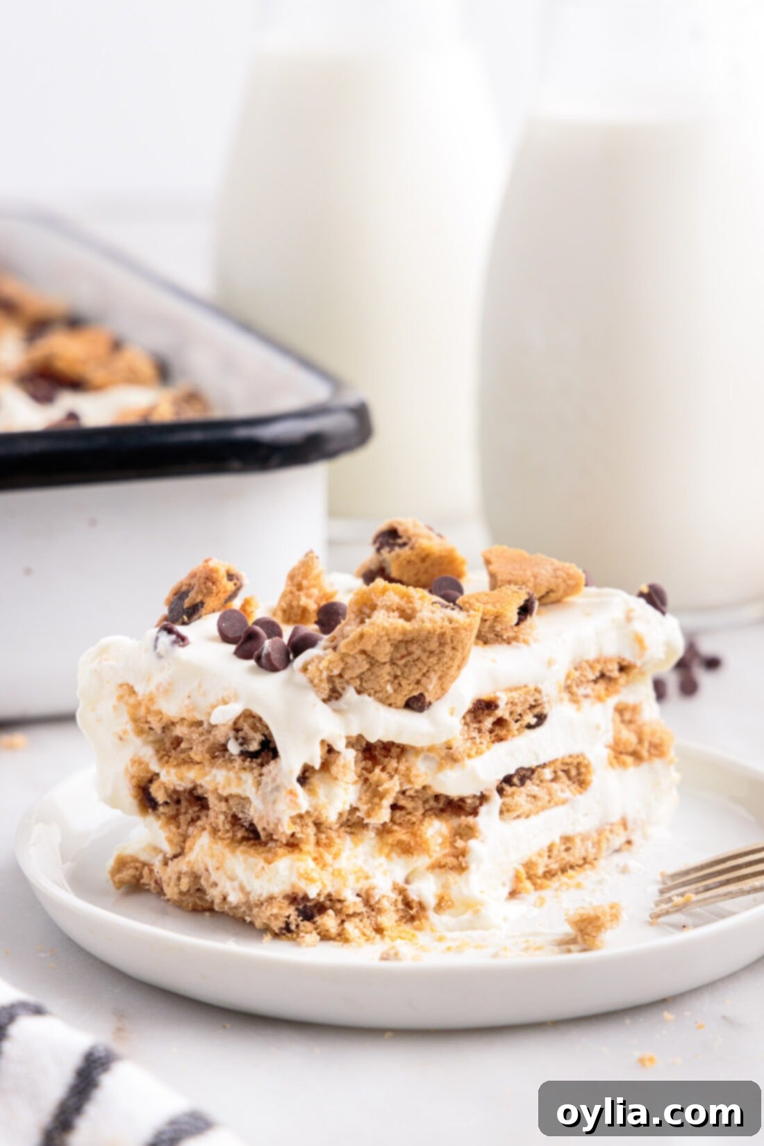 A beautiful slice of Chocolate Chip Cookie Icebox Cake with a bite removed, showcasing its layers and soft, cake-like texture
