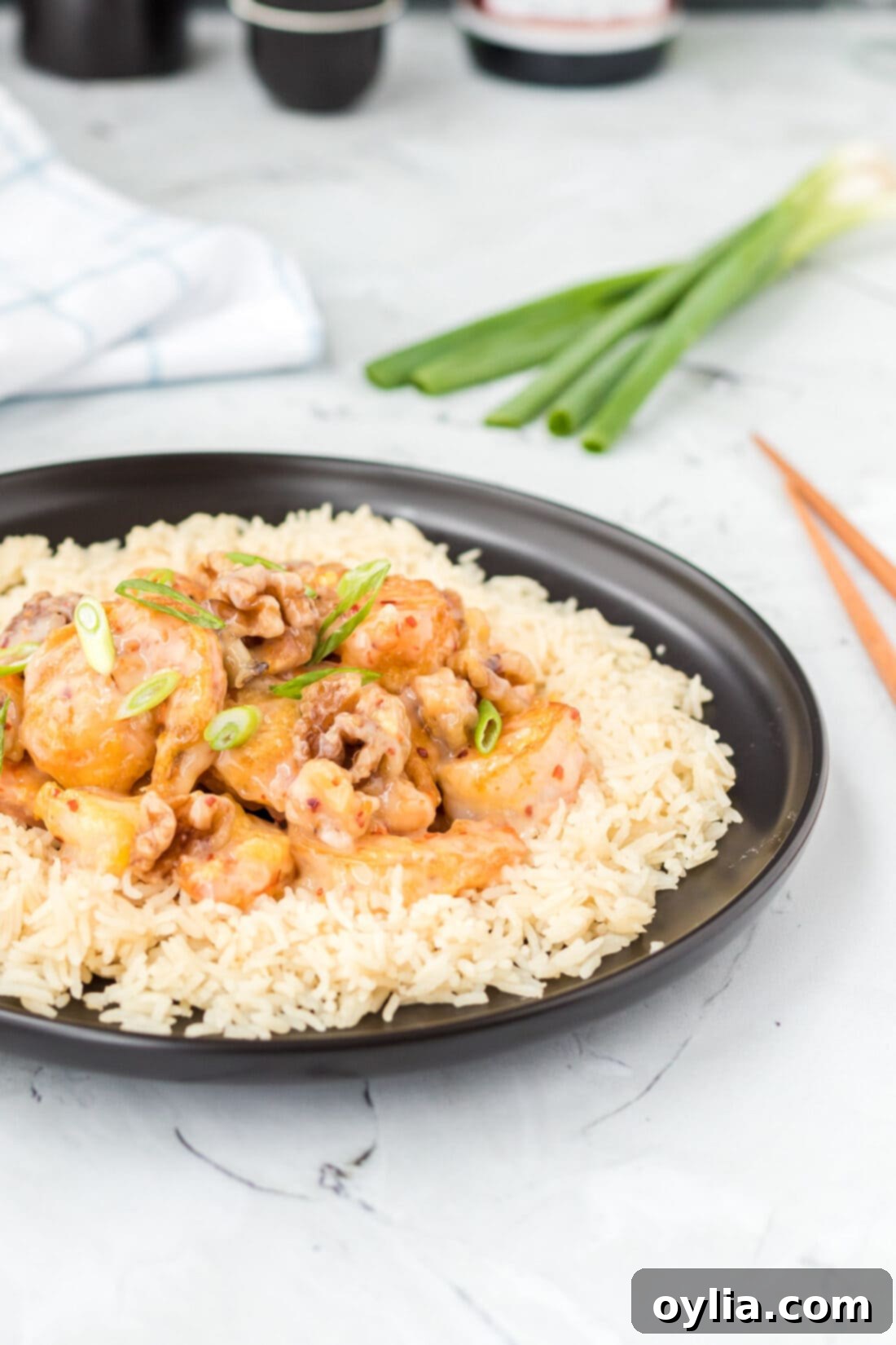 Plate of Honey Walnut Shrimp served alongside a bed of white rice, ready to be enjoyed.