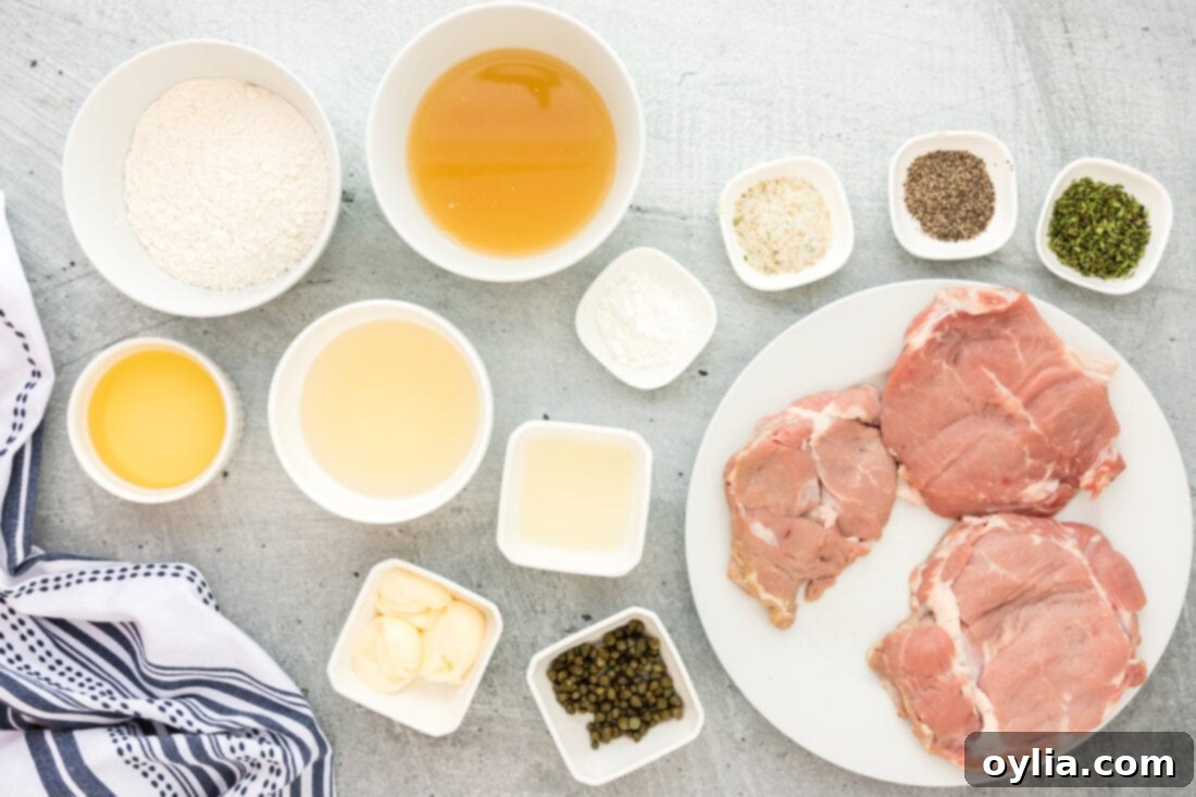Veal Piccata ingredients laid out on a wooden cutting board