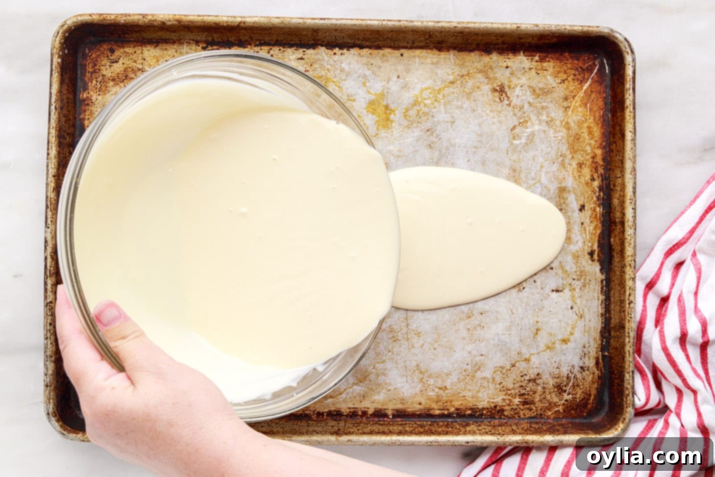pouring rolled ice cream ingredients into a pan