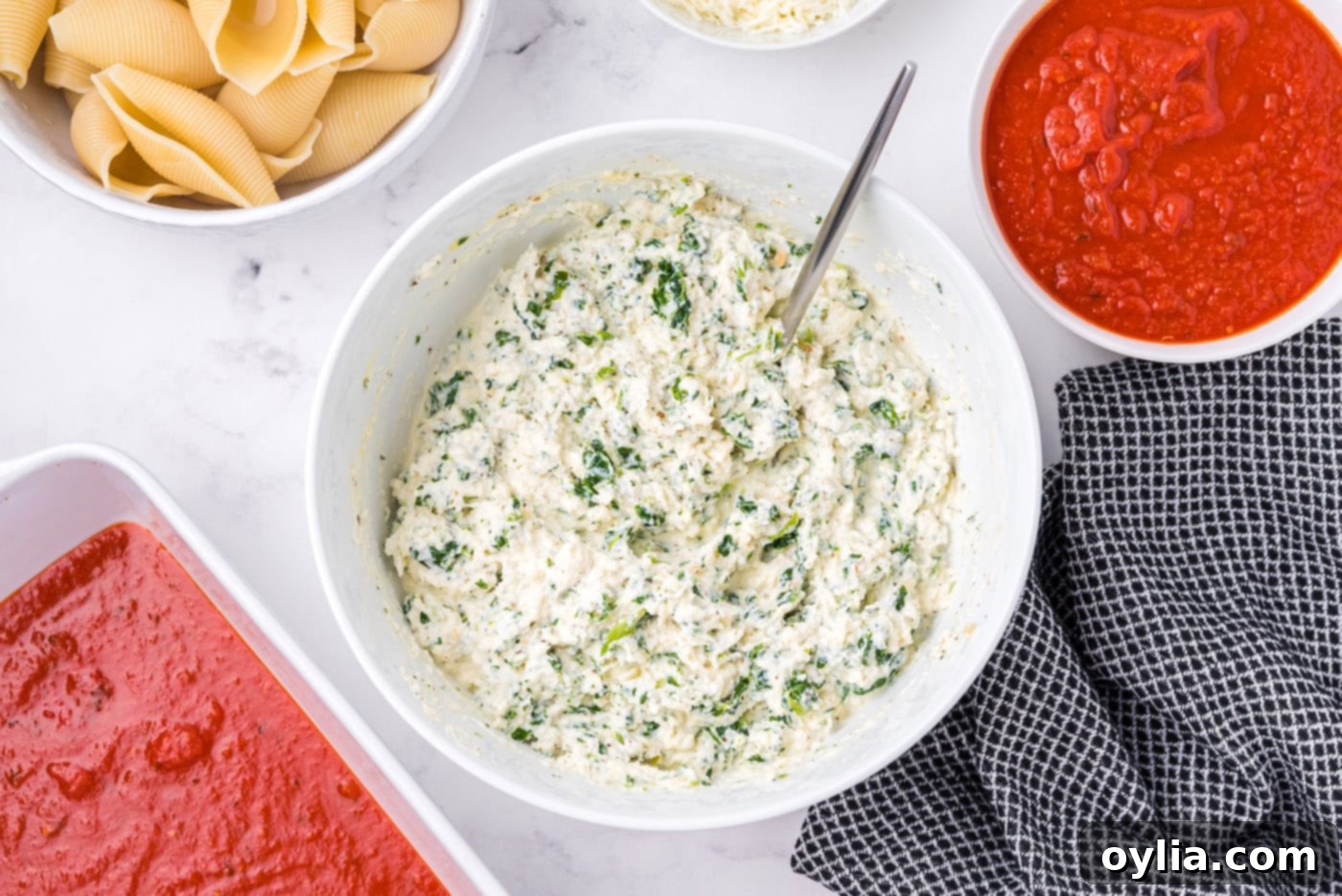 ricotta, parmesan, and spinach mixed in a bowl