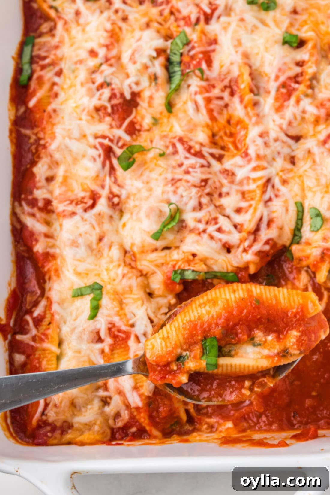 spoon in a pan of Stuffed Shells