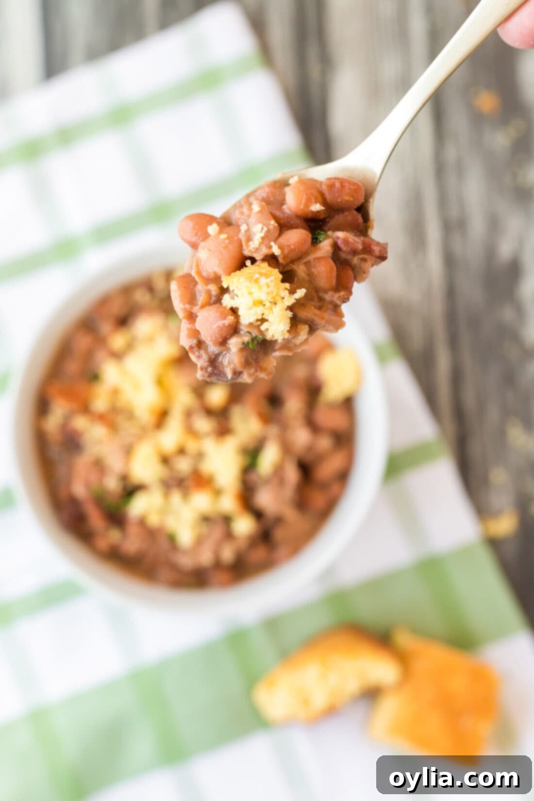 Delicious slow cooker pinto beans served with a side of cornbread