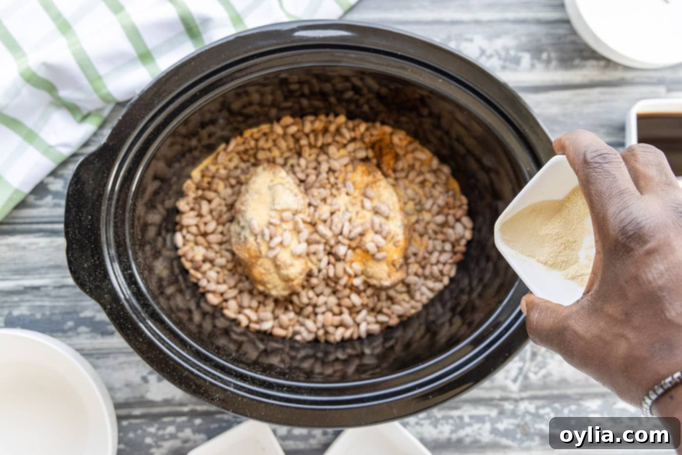 Adding the remaining pinto beans over turkey tails and seasonings