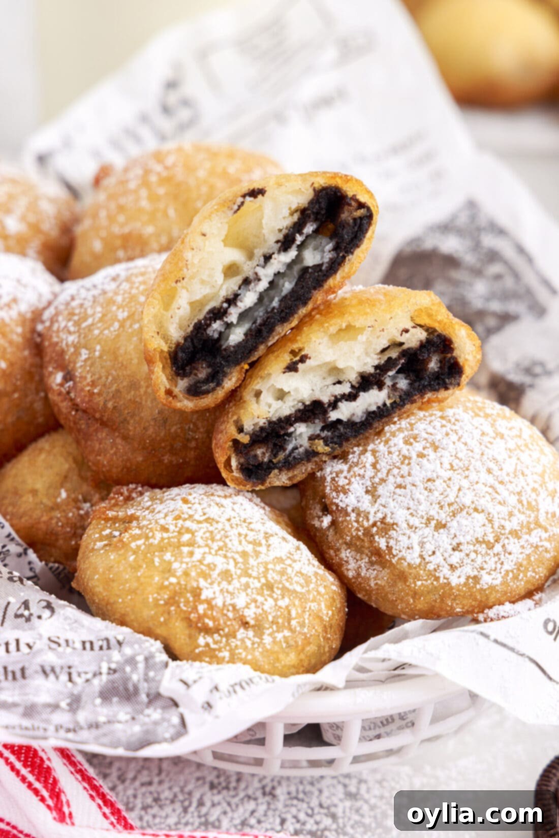 A basket of freshly made Fried Oreos dusted with powdered sugar, ready to be served.
