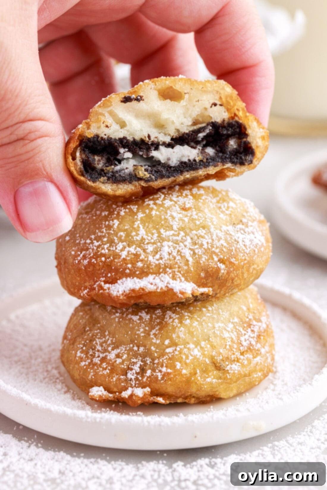 A stack of golden brown, freshly made Fried Oreos, showing off their indulgent layers.