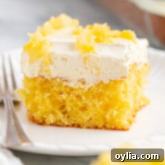 Beautiful square image of Pineapple Sunshine Cake with fluffy frosting
