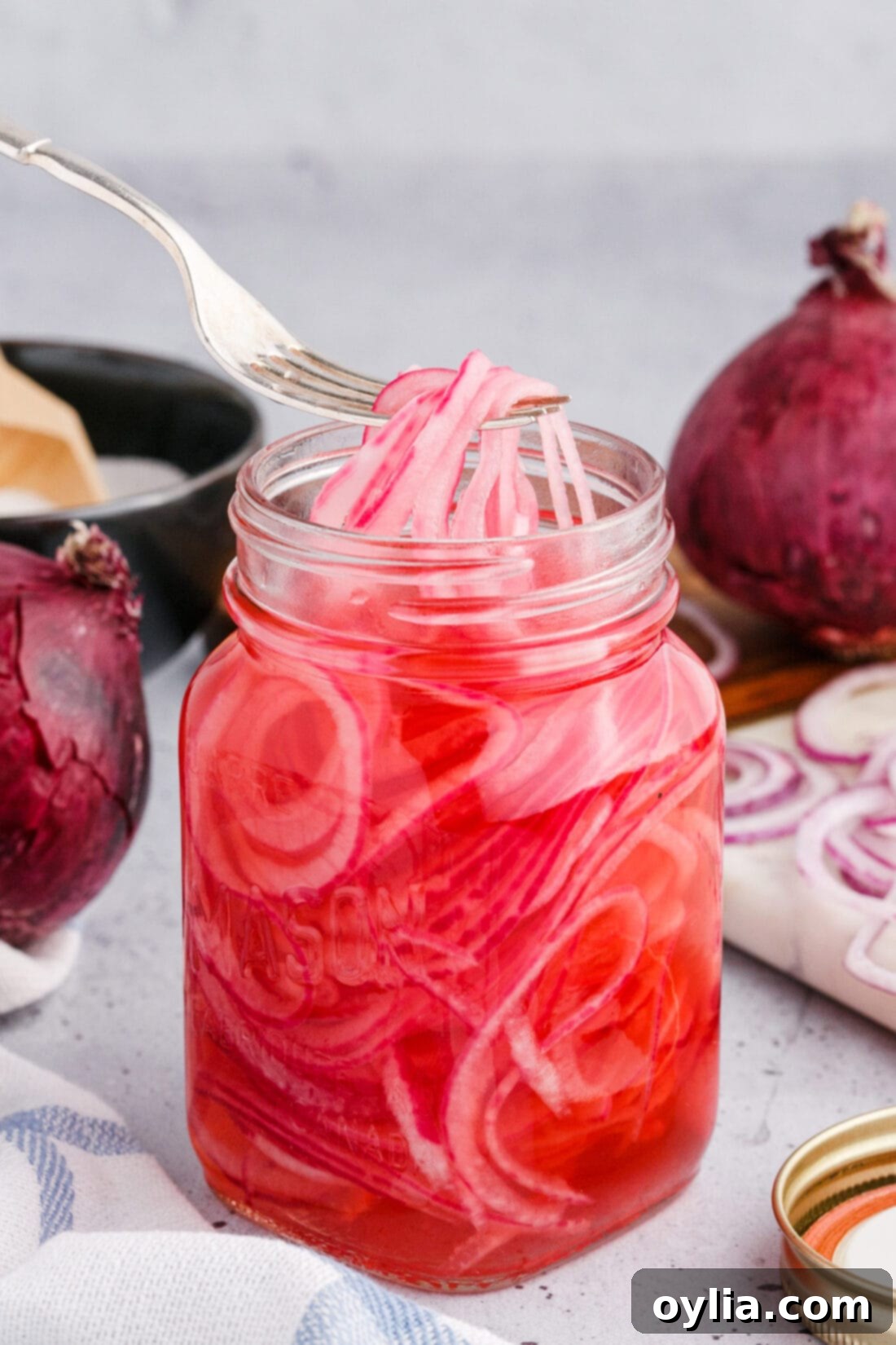 Vinegar-Kissed Onions 8 A mason jar filled with perfectly pink homemade pickled red onions, ready for the refrigerator