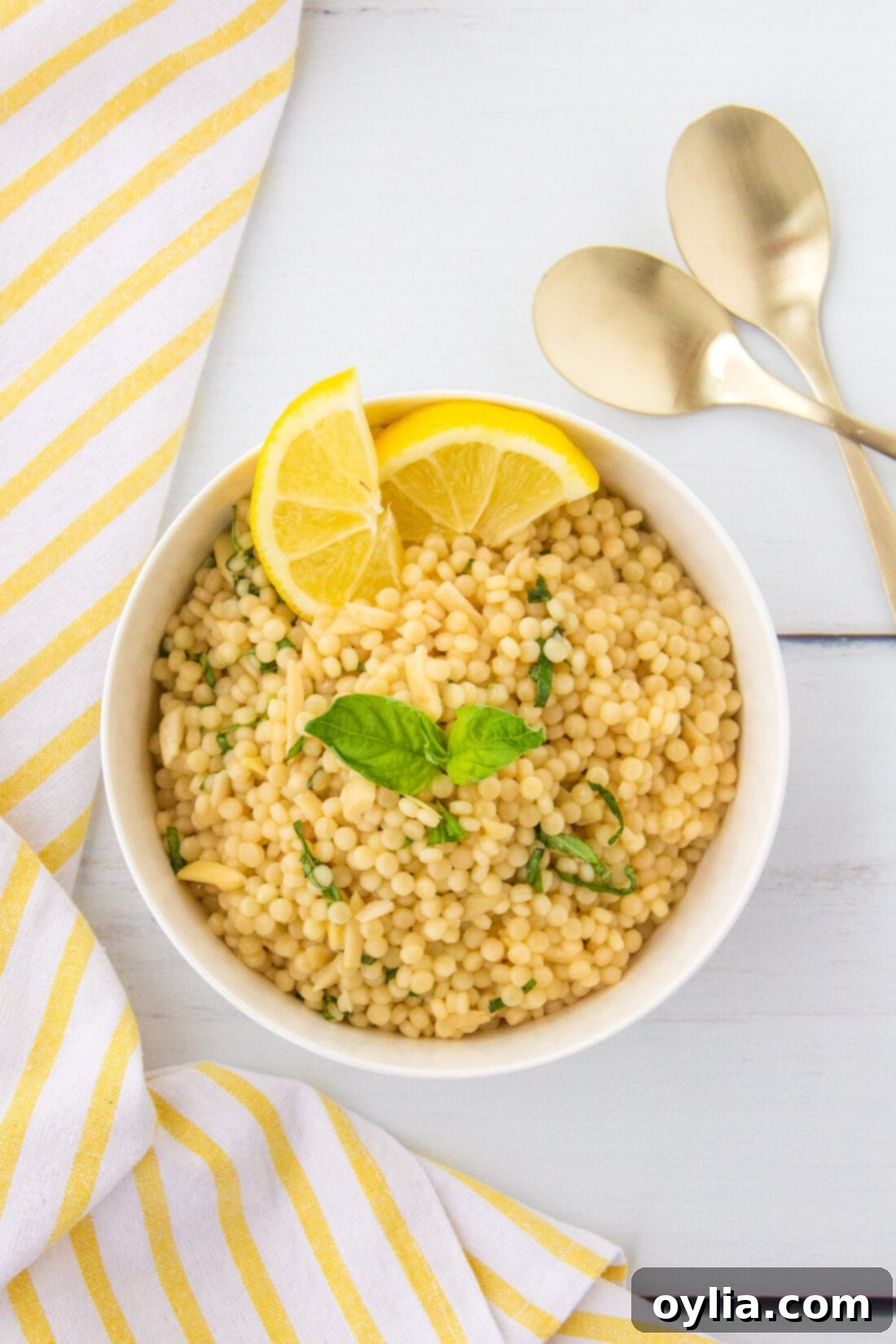 Sunshine Lemon Couscous 8 An overhead shot of the bright and zesty lemon couscous, featuring the pearl couscous, green basil, and golden slivered almonds.
