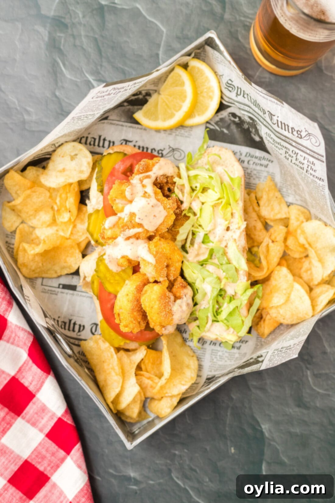 A Shrimp Po Boy served in a basket with a side of potato chips, ready to be enjoyed.