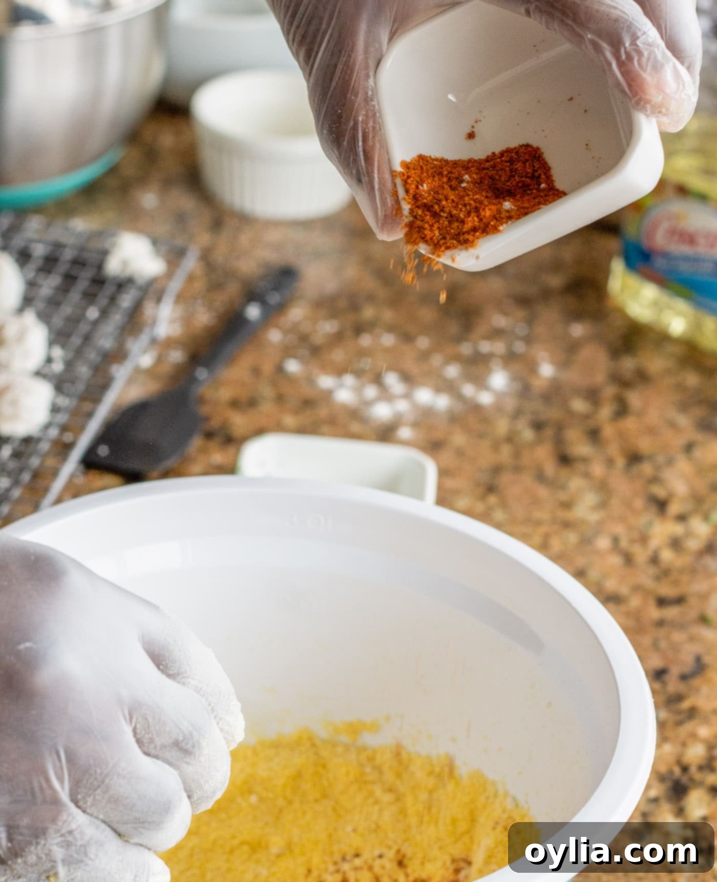 Adding Old Bay seasoning to the egg and milk mixture for shrimp.