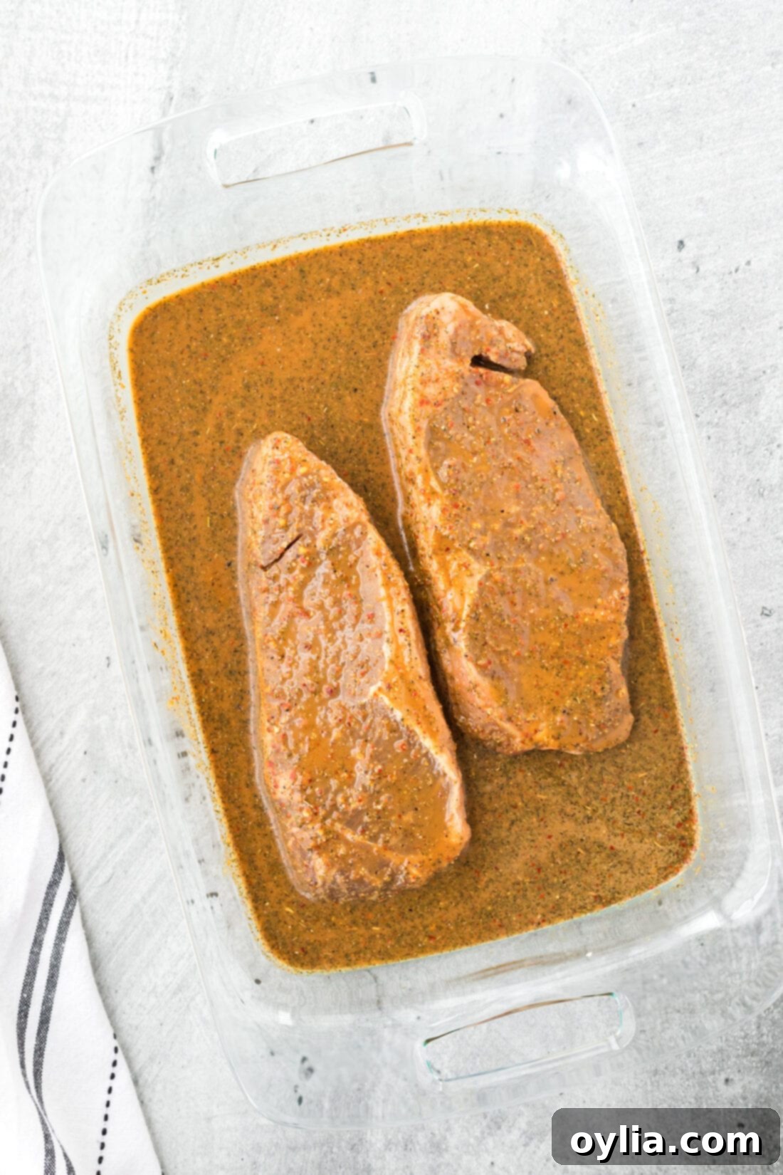 Unlock Ultimate Steak Flavor 2 Delicious steak marinating in a pan with homemade easy steak marinade