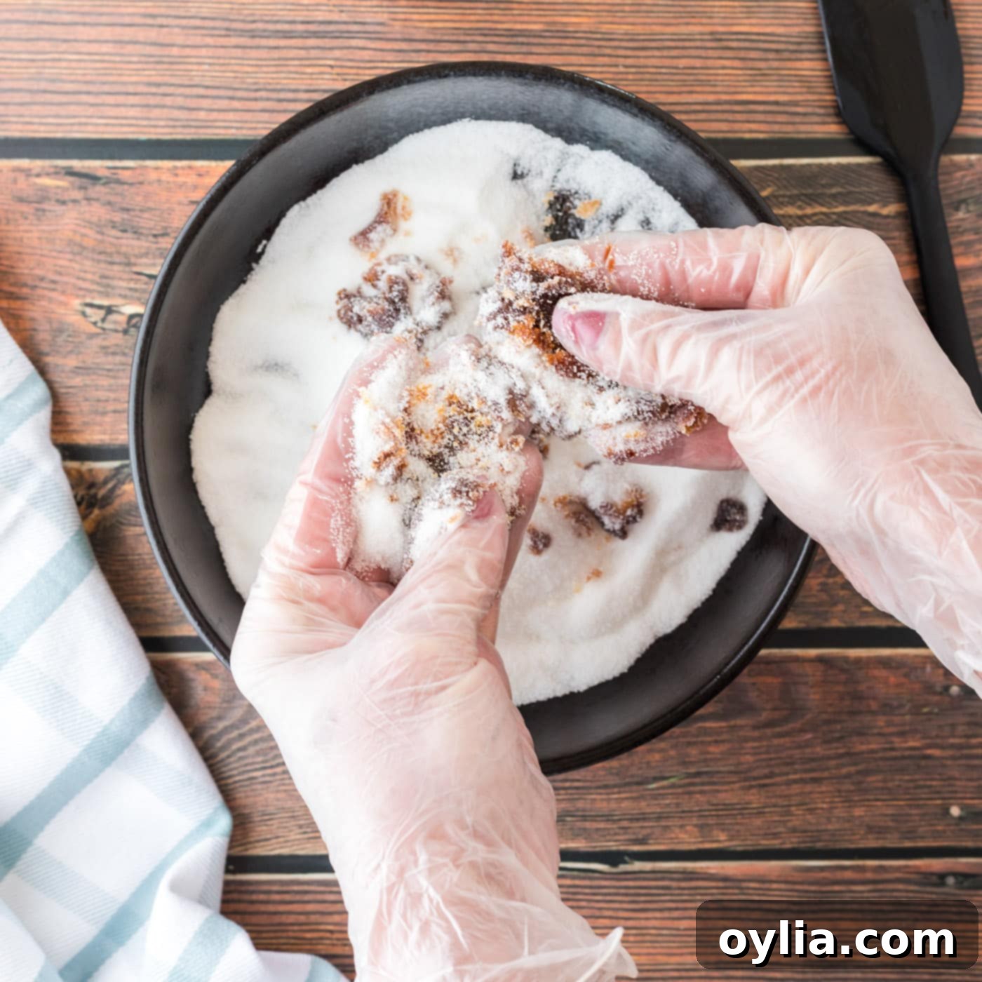 hands mixing molasses and sugar together