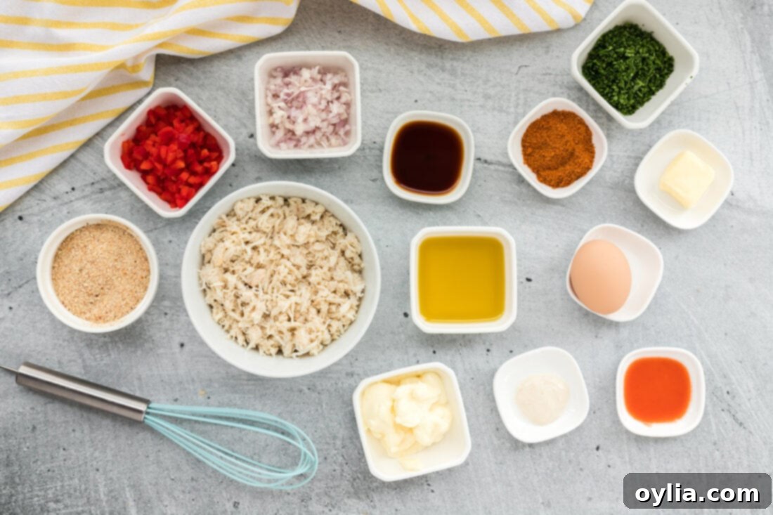 Arrangement of fresh ingredients including crab meat, bell pepper, shallots, and seasonings for making crab cakes