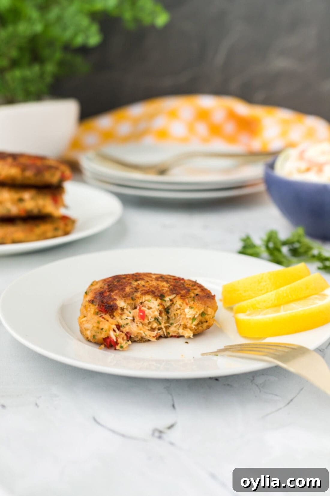 Close-up of a crab cake with a bite removed, revealing the tender, flavorful interior