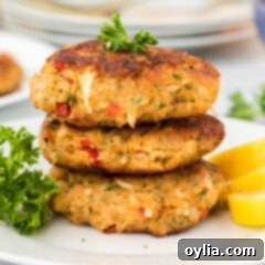 Crab Cakes on plate, garnished with parsley and a lemon wedge