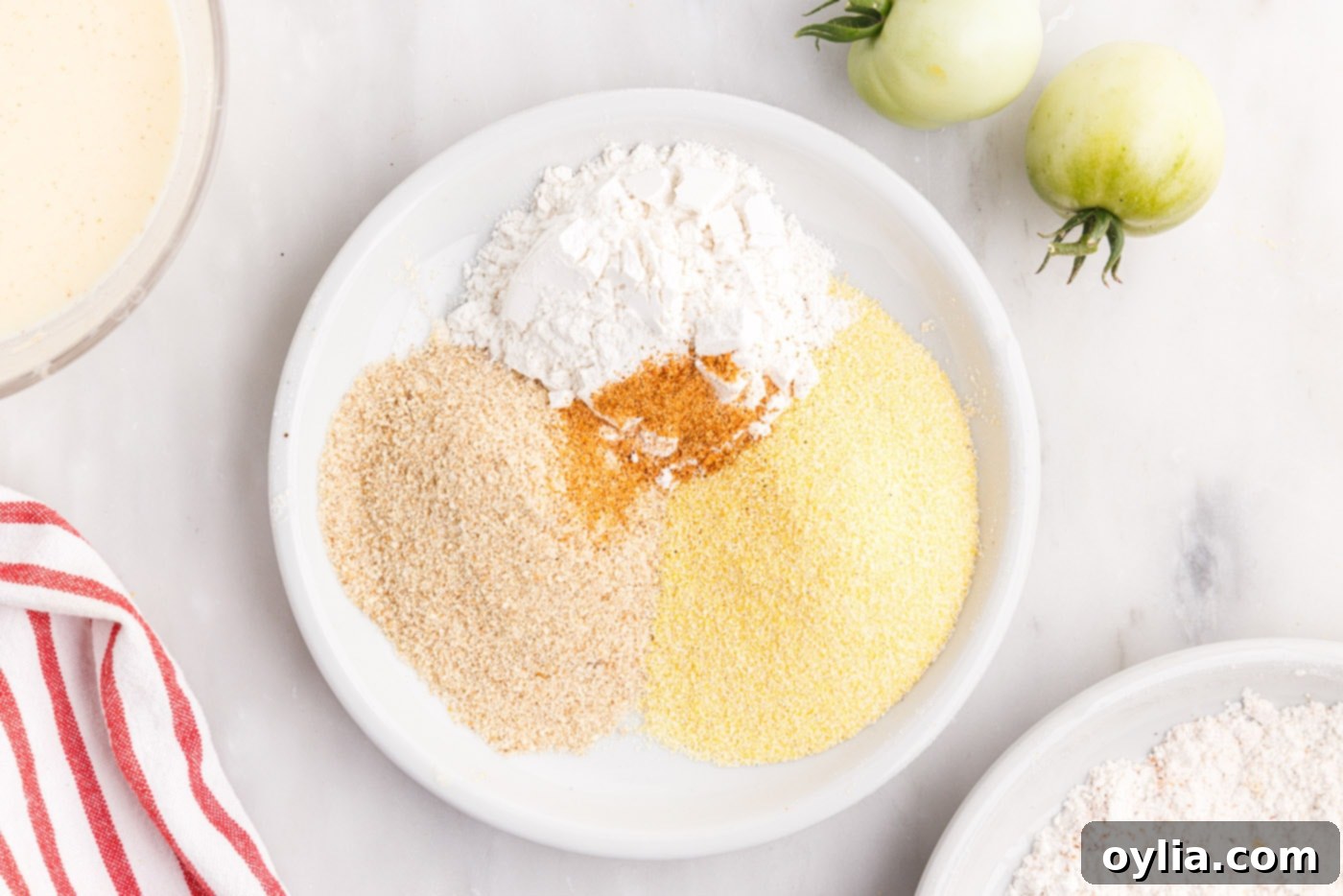 flour, cornmeal, cajun seasoning, and breadcrumbs for fried tomatoes
