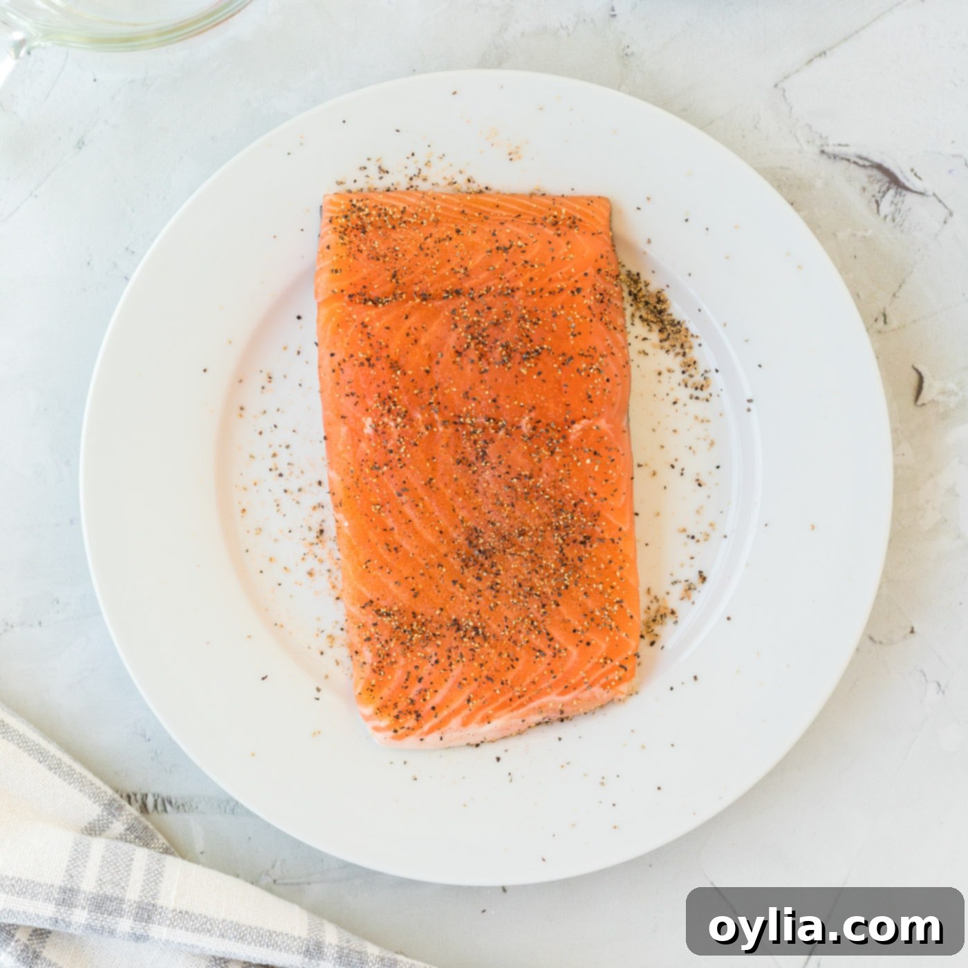 center cut salmon filet seasoned on a plate