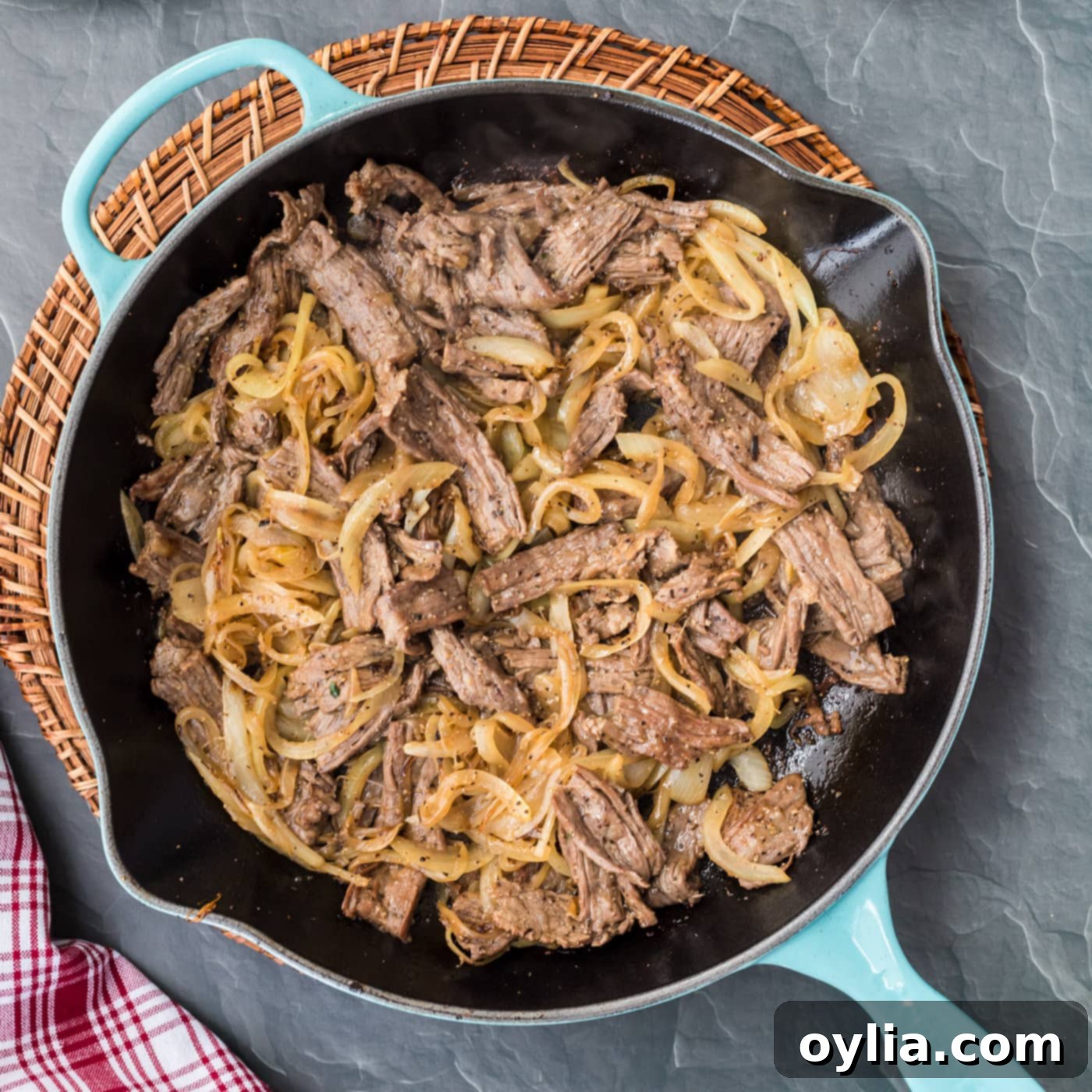 philly cheesesteak ingredients in a skillet