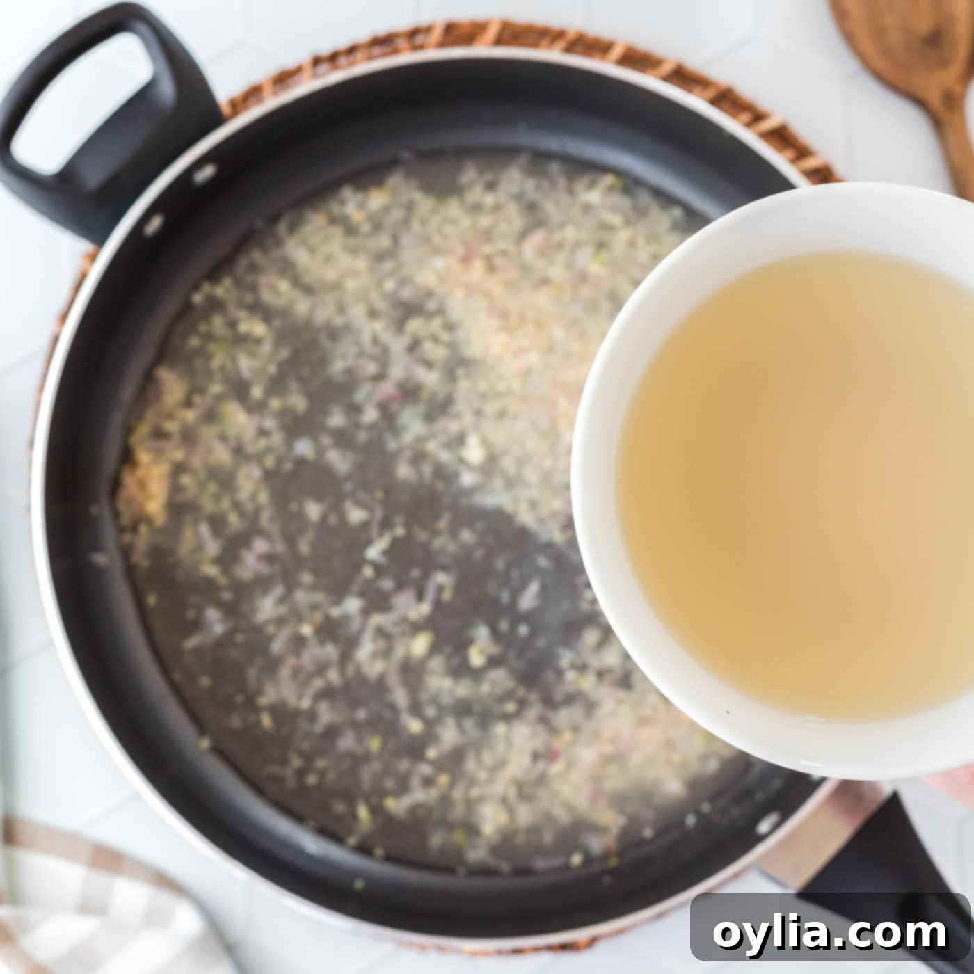 pour clam juice into pan with shallots and garlic