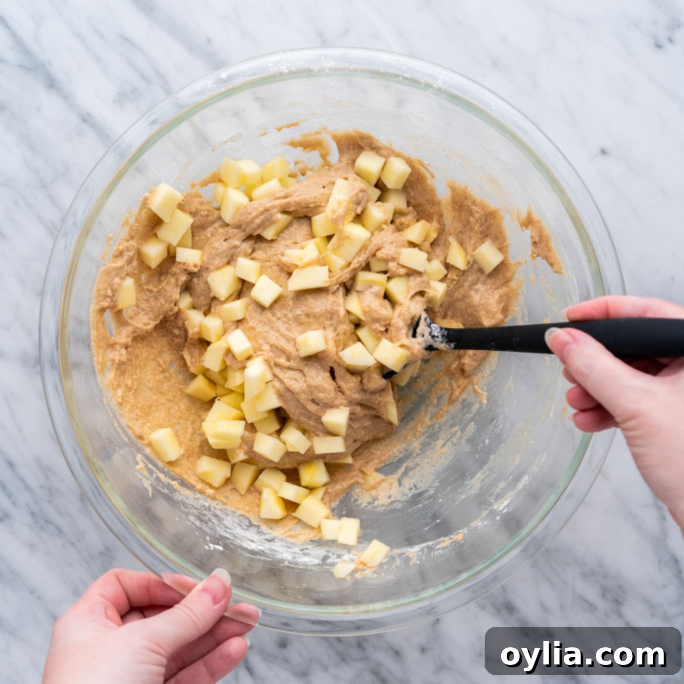 folding chopped apples into apple fritter batter
