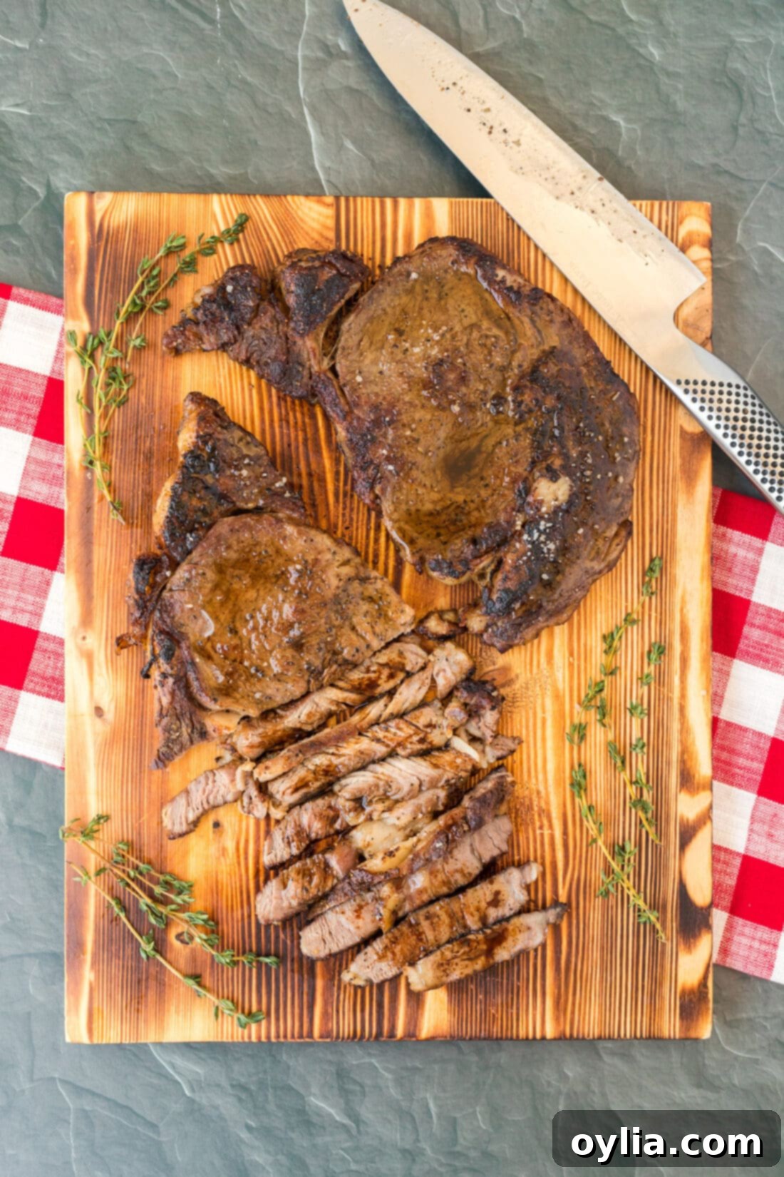 Perfectly cooked Reverse Sear Ribeye steak on a wooden cutting board, ready to be sliced