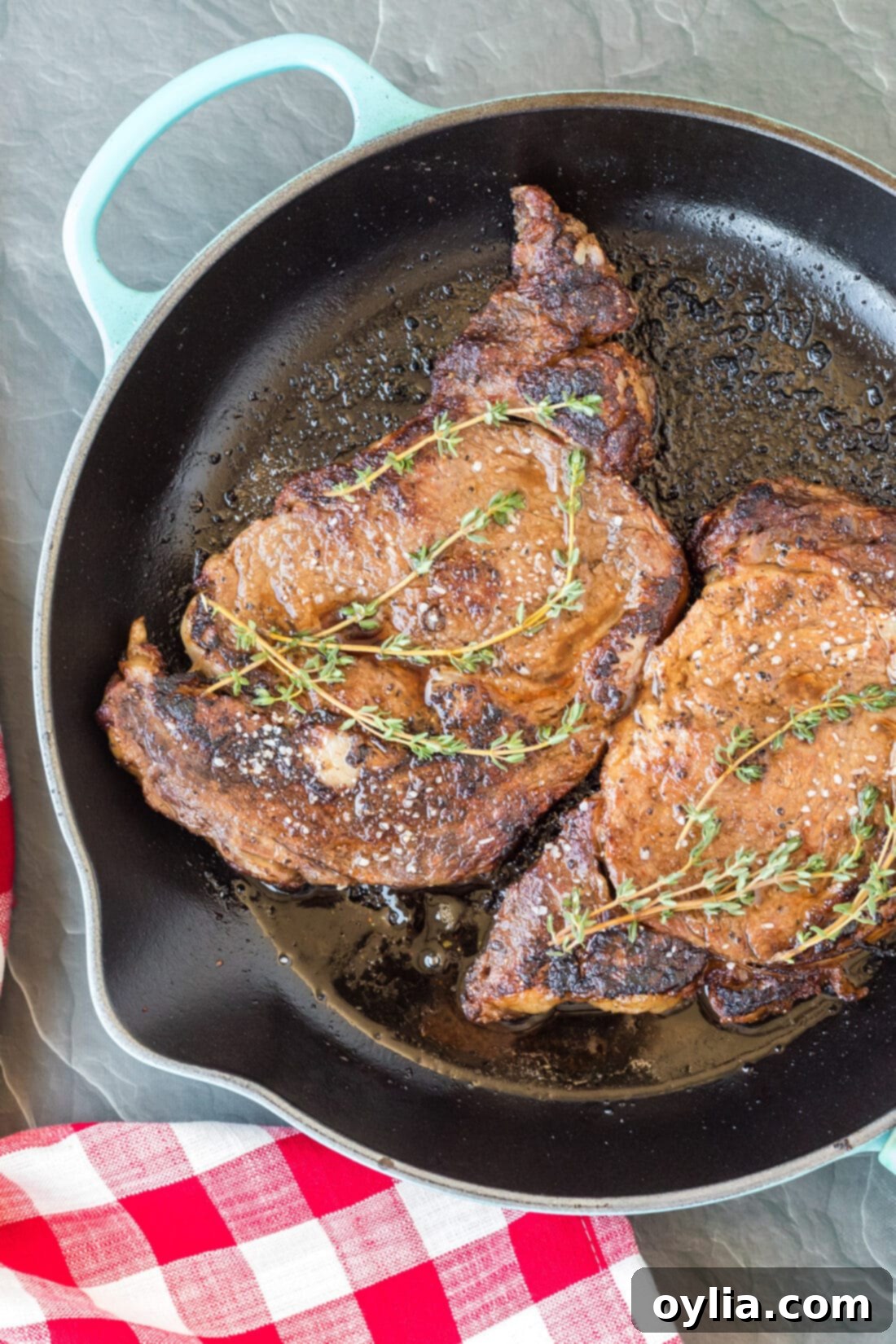 Reverse Sear Ribeye steak sizzling vigorously in a hot cast iron skillet, developing a crust