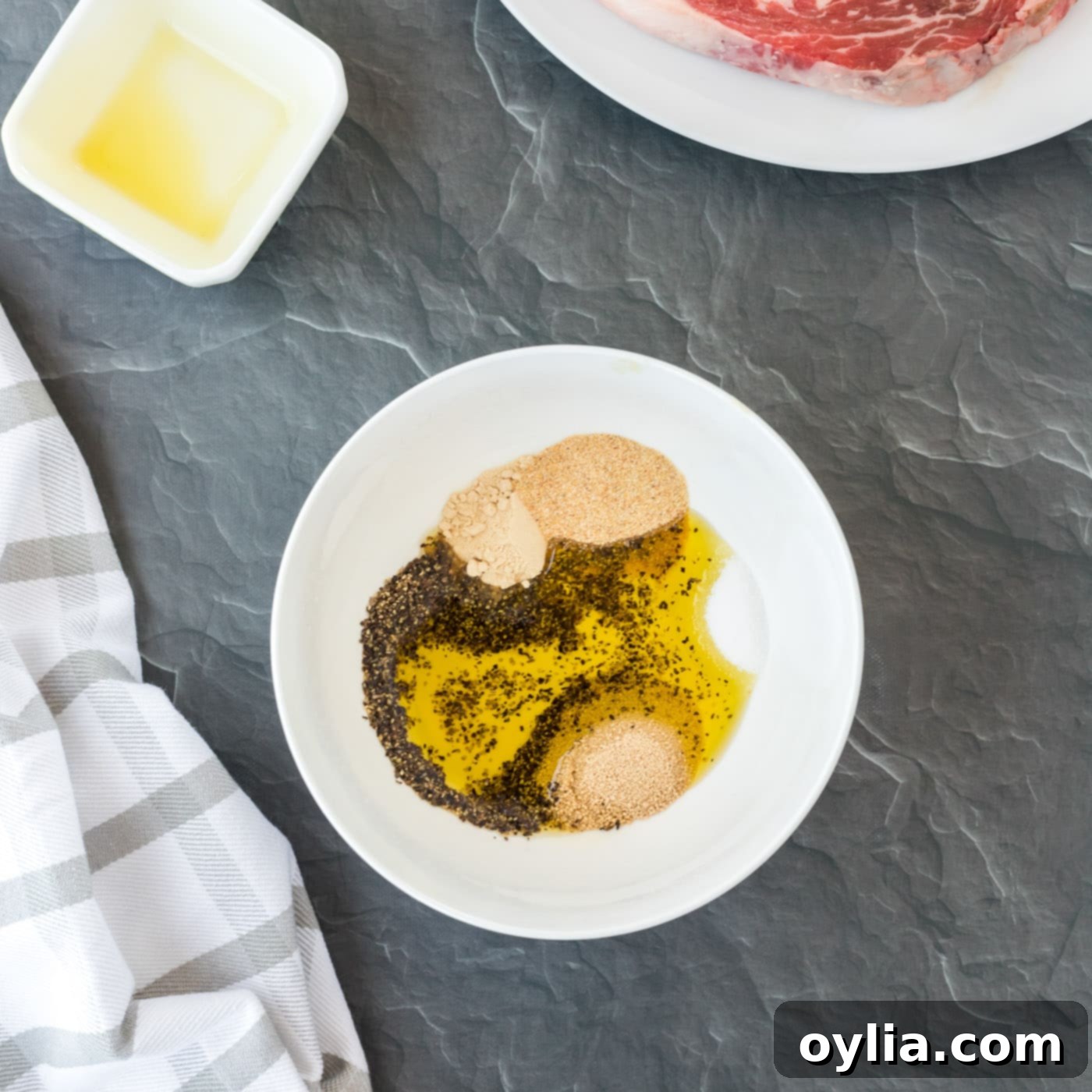 A bowl filled with a wet rub mixture of olive oil, brown sugar, and spices, ready for steak seasoning.