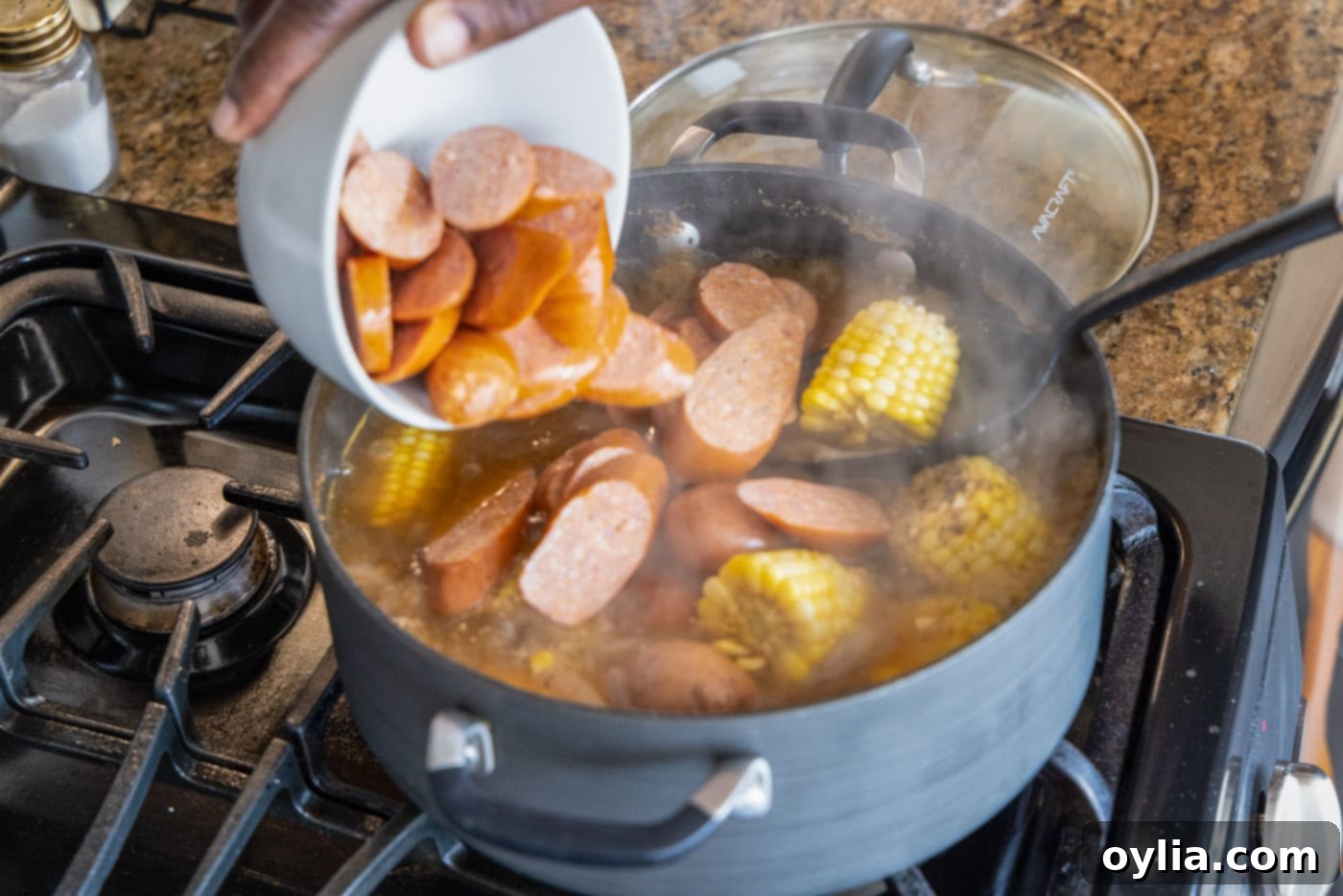 adding sausage to shrimp boil