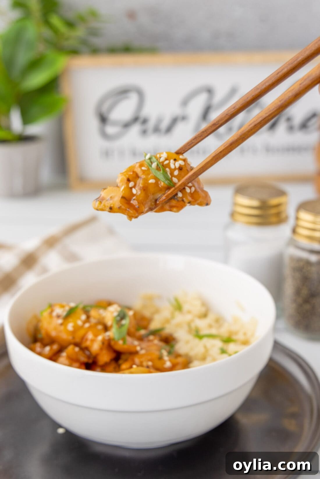 lifting Bourbon Chicken with chopsticks